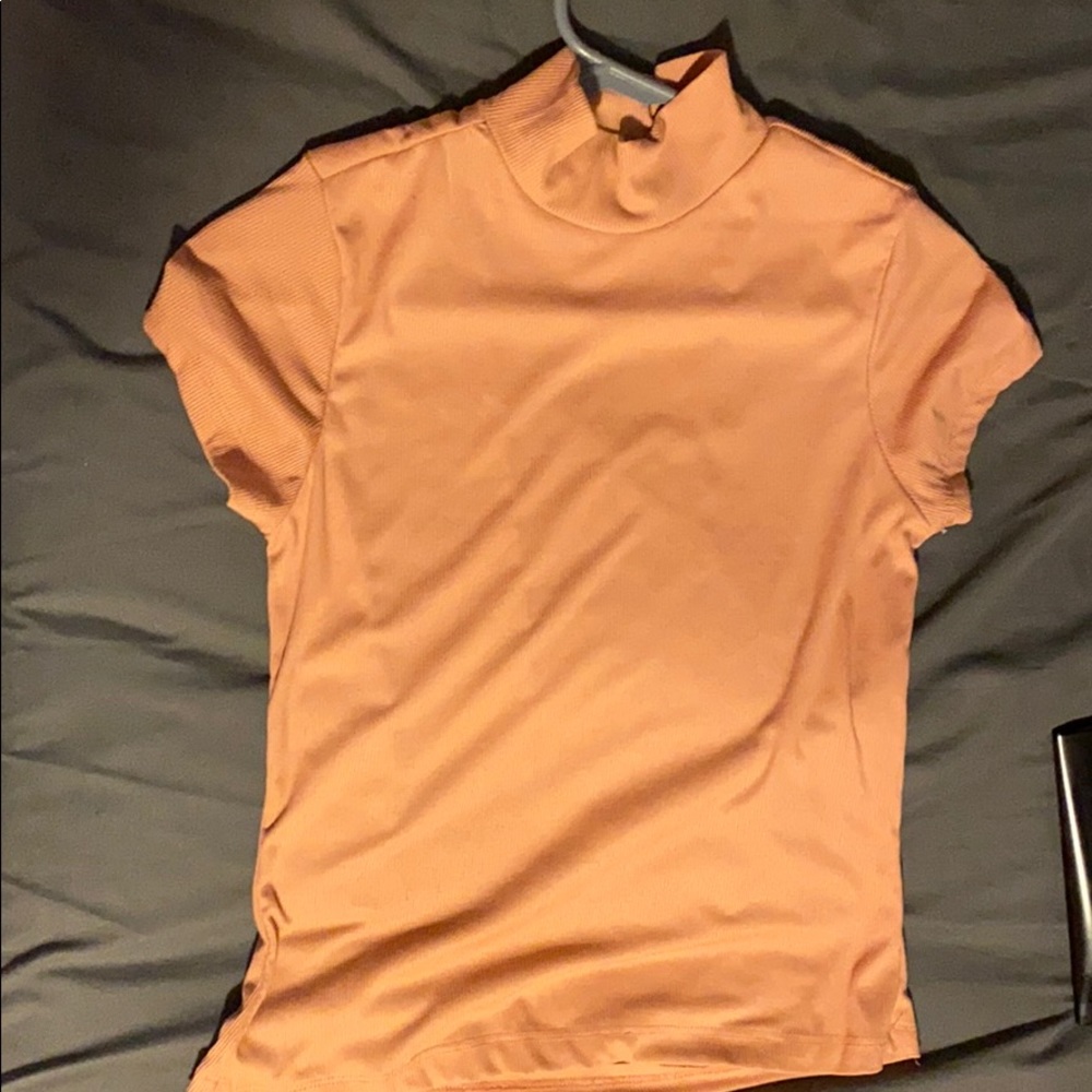 A peach color mock turtleneck